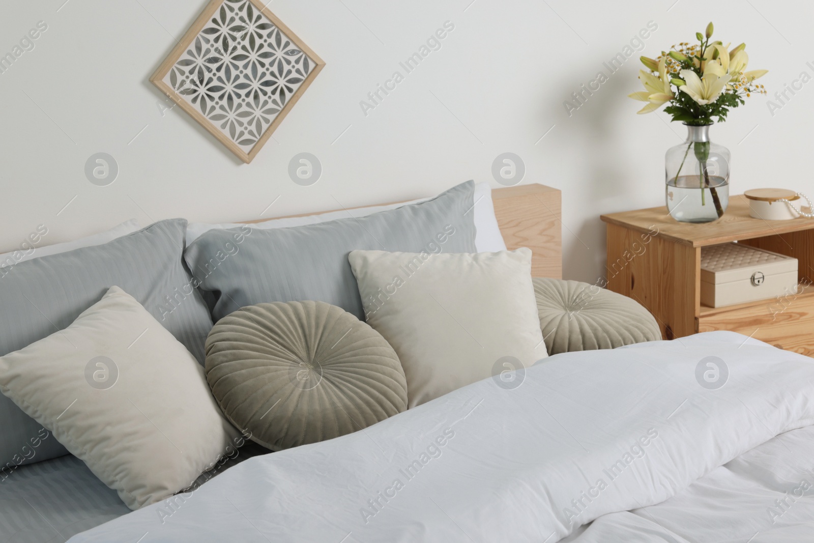 Photo of Beautiful bedroom interior with fresh flowers and decor