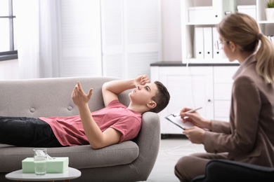 Photo of Psychotherapist working with young man in office