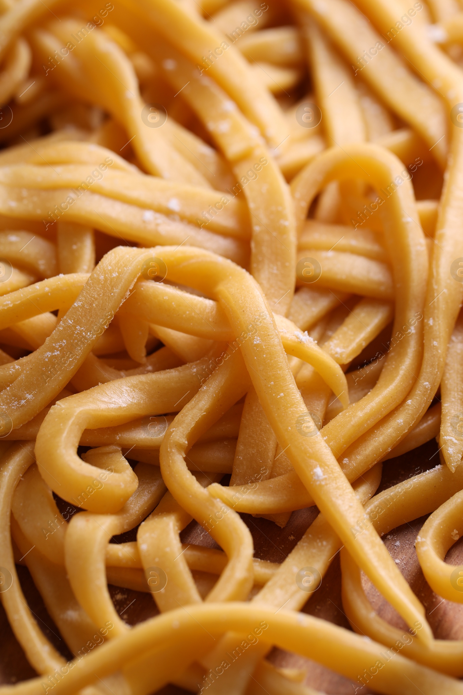 Photo of Raw homemade pasta on table, closeup view