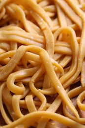 Photo of Raw homemade pasta on table, closeup view