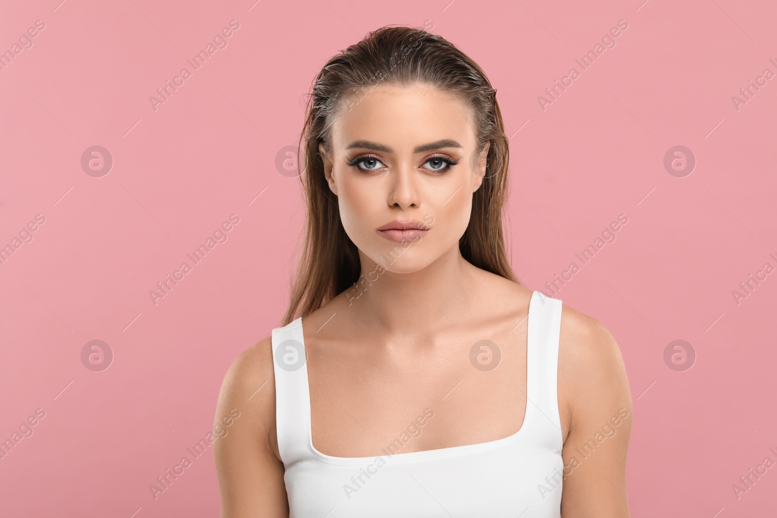 Photo of Beautiful woman with makeup on pink background