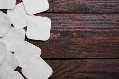 Photo of Many clean cotton pads on wooden table, flat lay. Space for text