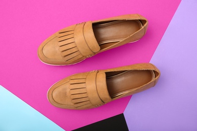 Photo of Pair of female shoes on color background