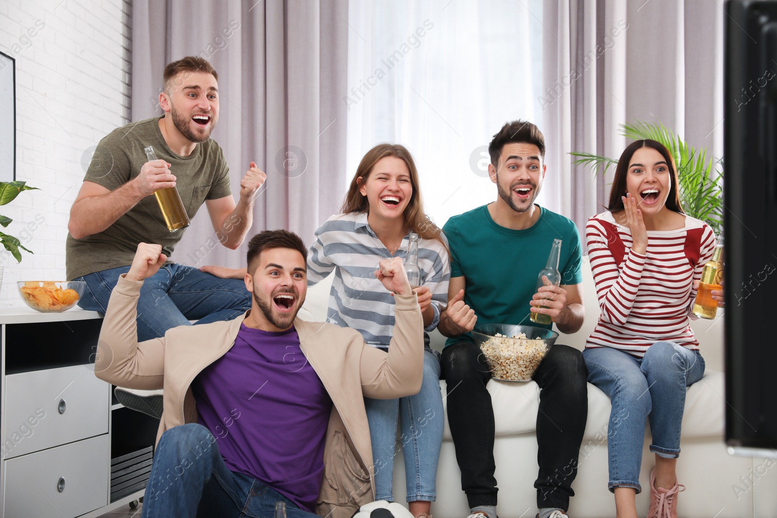 Photo of Group of friends watching football at home