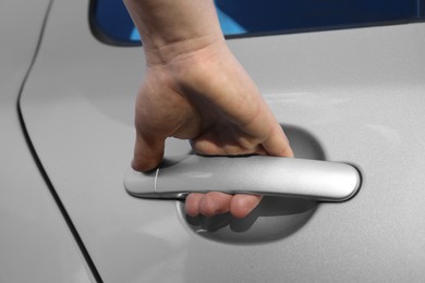 Photo of Closeup view of man opening car door