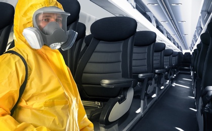 Man wearing protective suit cleaning cabin in airplane to prevent spreading of Coronavirus