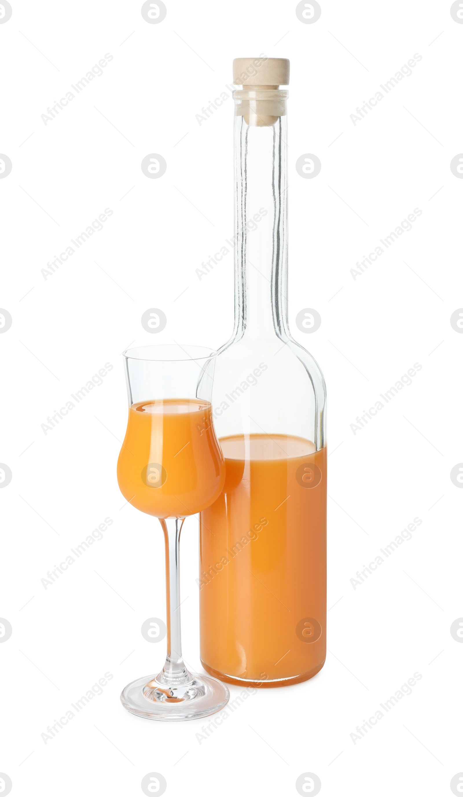 Photo of Bottle and glass with tasty tangerine liqueur isolated on white