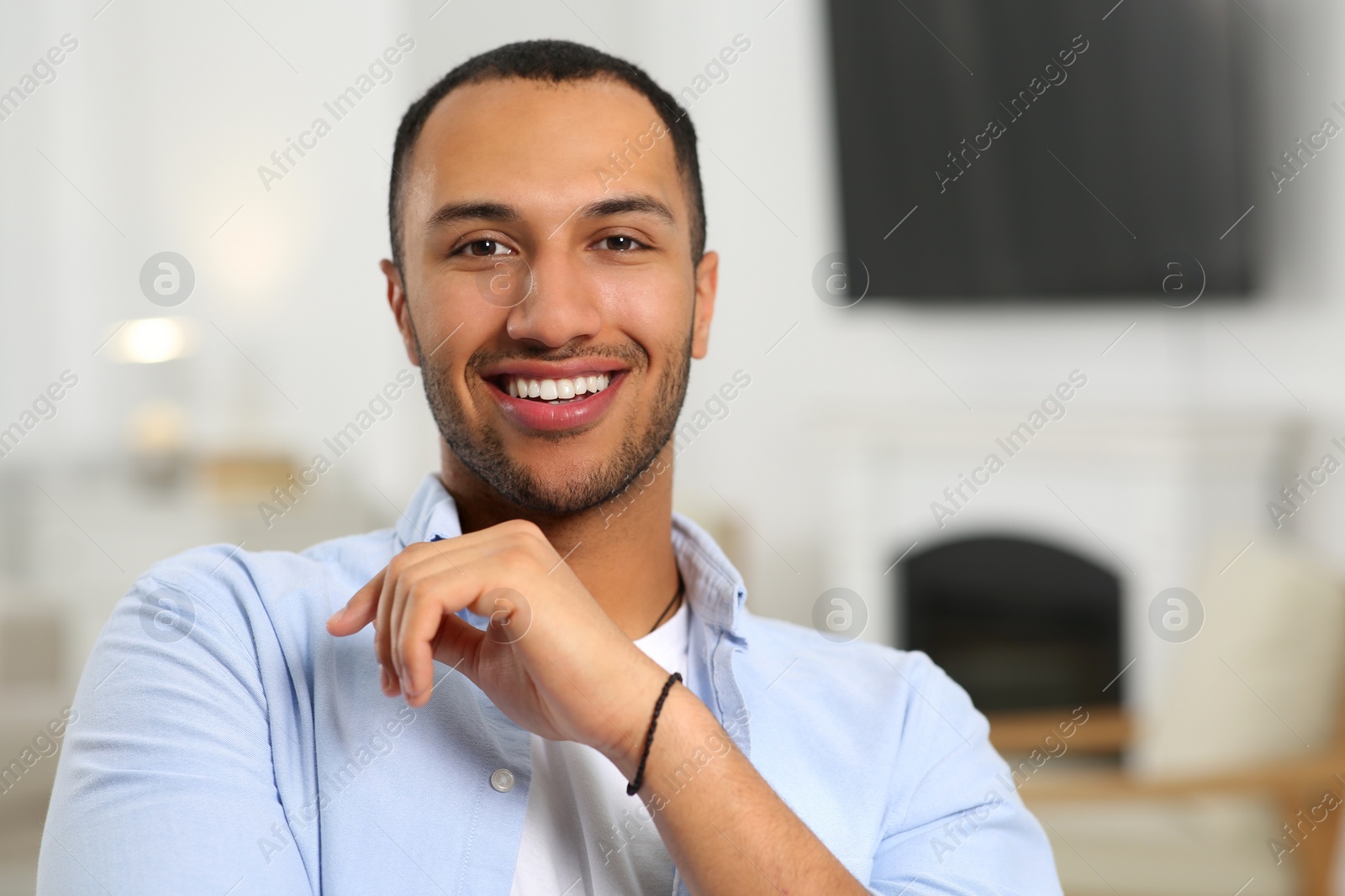 Photo of Portrait of smiling African American man at home. Space for text