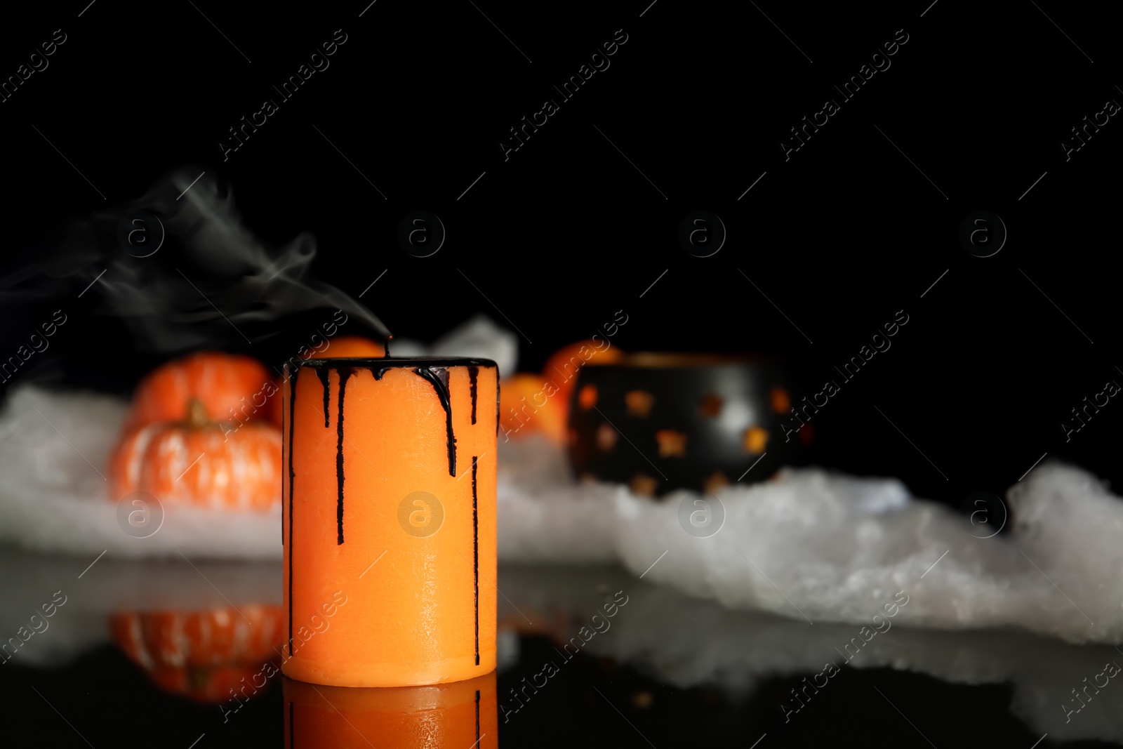 Photo of Candle and decor on black background. Halloween celebration