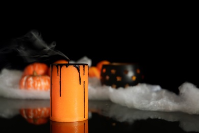 Photo of Candle and decor on black background. Halloween celebration