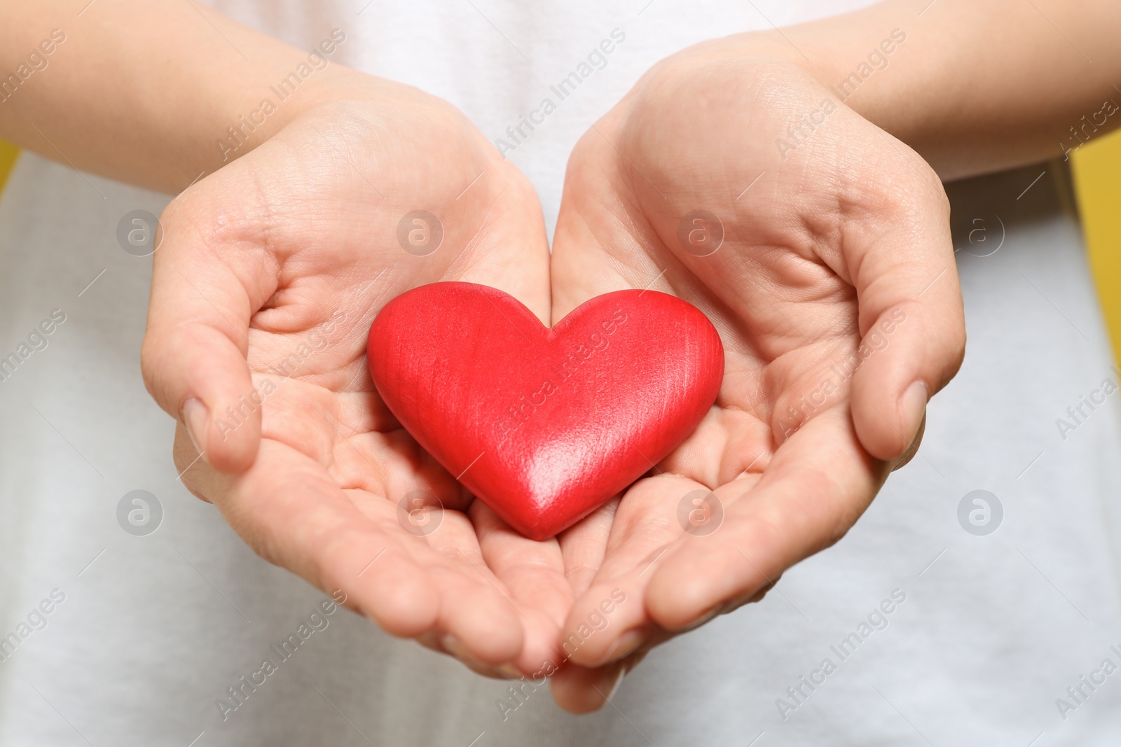 Photo of Woman holding red heart, closeup. Donation concept