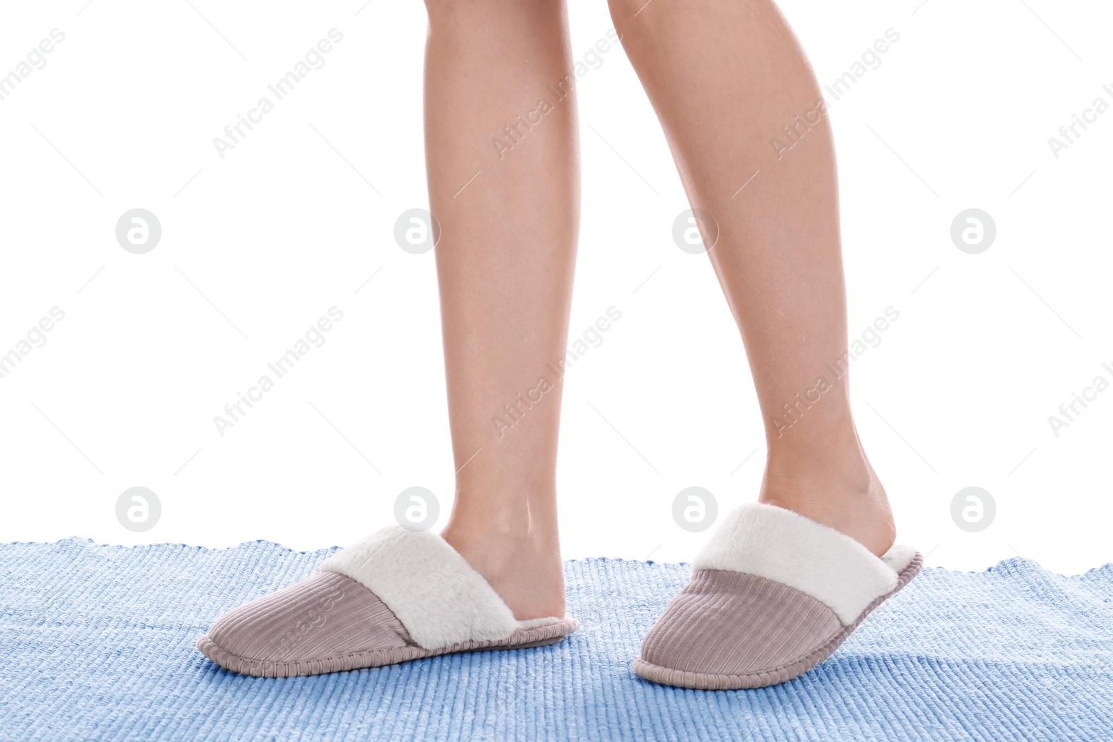 Photo of Woman in warm soft slippers on white background, closeup