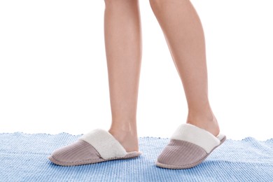 Woman in warm soft slippers on white background, closeup