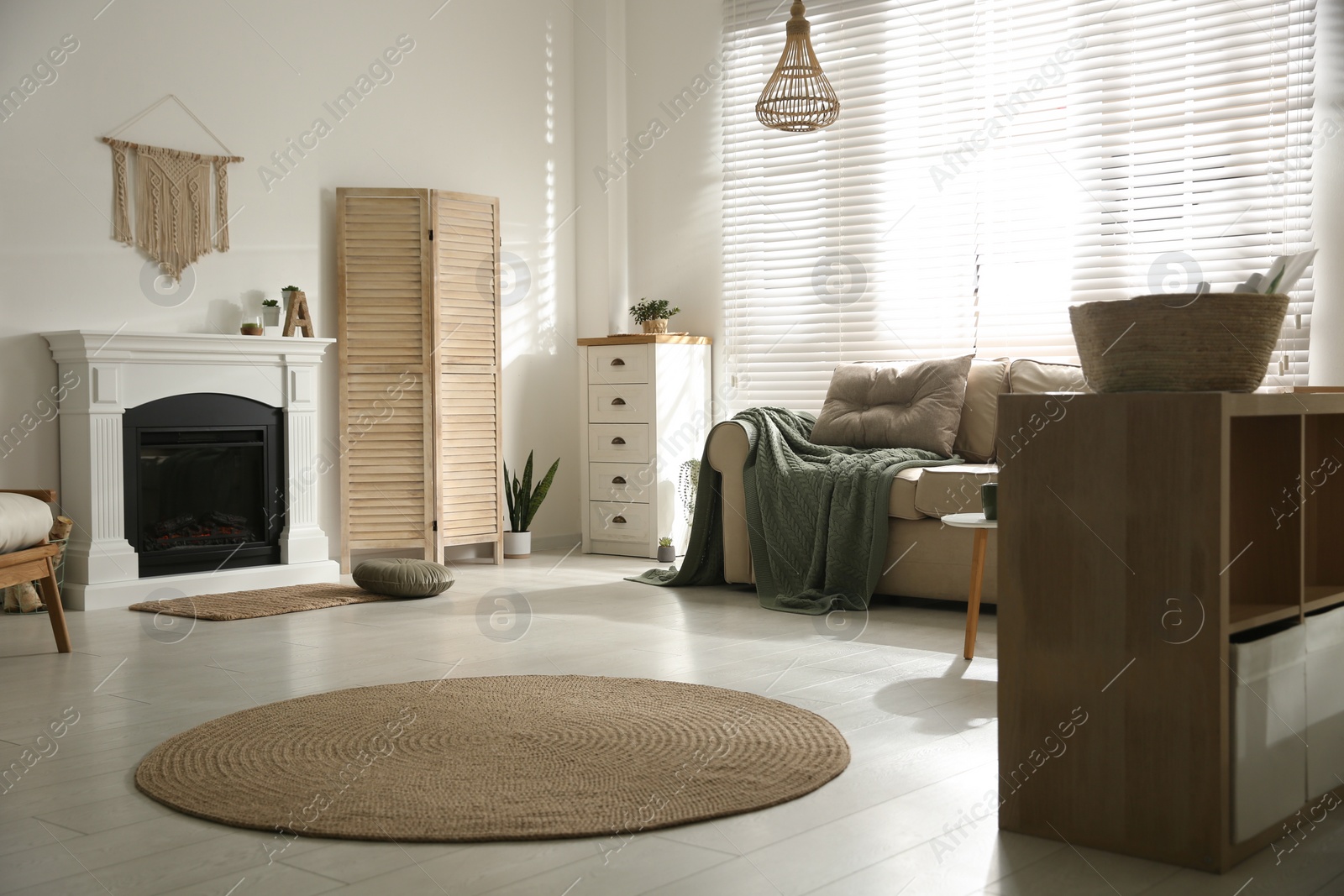 Photo of Bright living room interior with fireplace, sofa and drawer