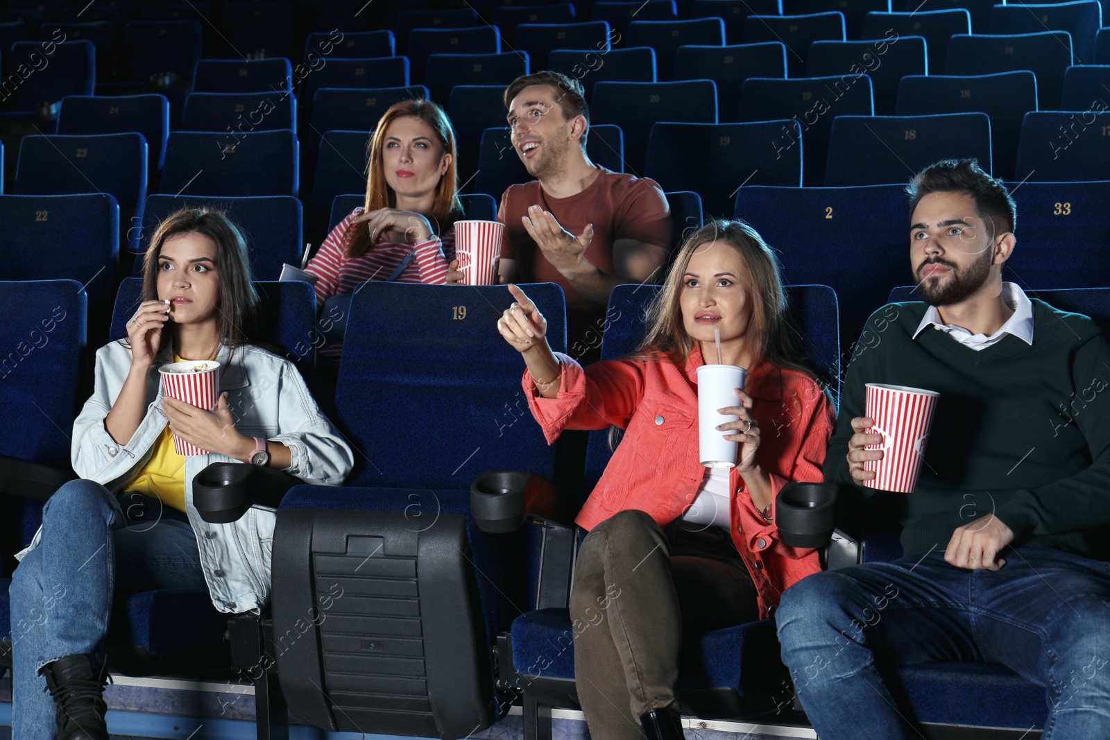 Photo of Young people watching movie in cinema theatre