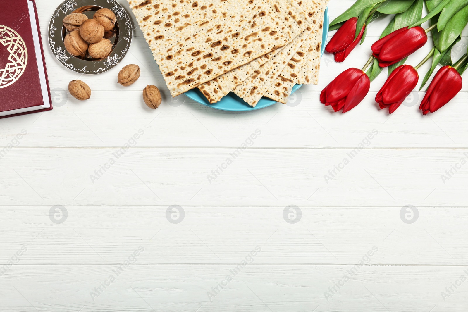 Photo of Flat lay composition with matzos on white wooden background, space for text. Passover (Pesach) celebration