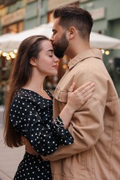 Lovely couple dancing together on city street