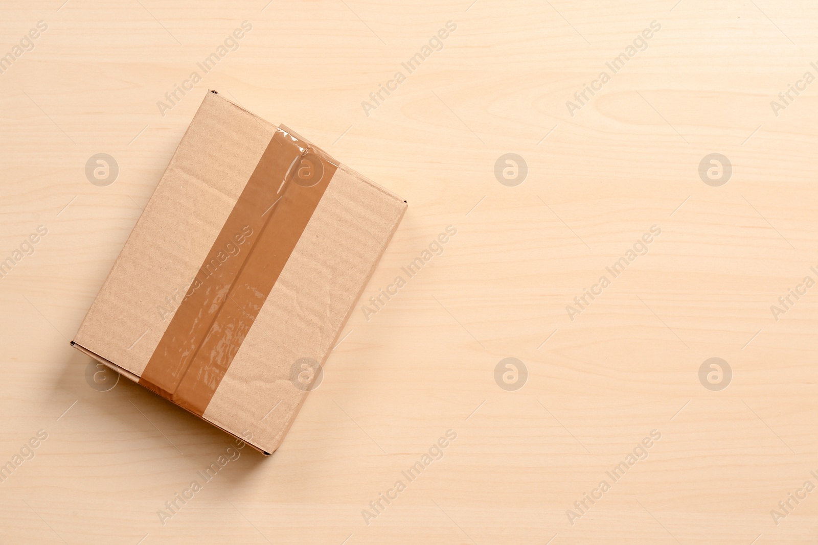 Photo of Cardboard box on wooden background