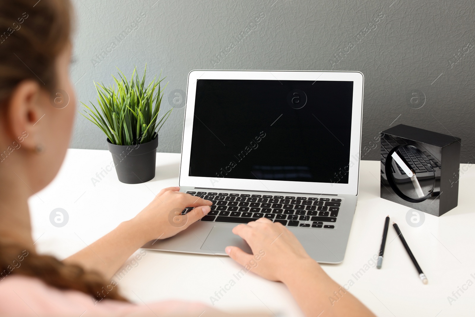 Photo of Woman working with laptop at home. Mock up with space for text