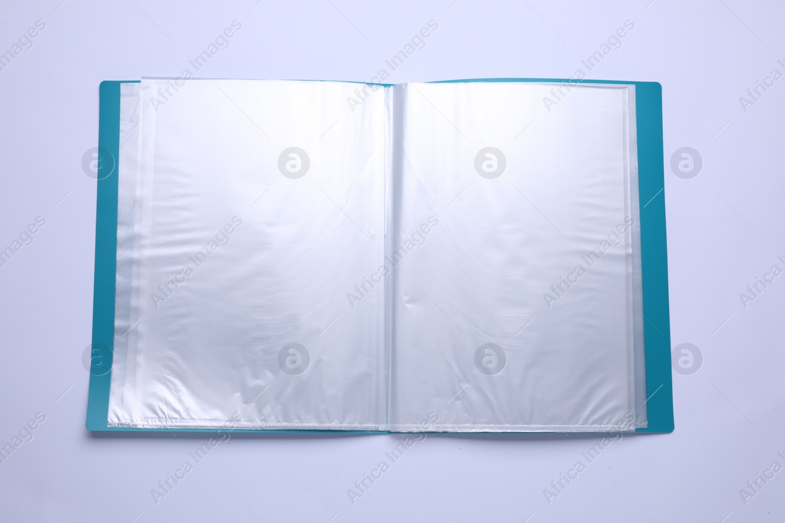 Photo of File folder with punched pockets and paper sheets isolated on white, top view