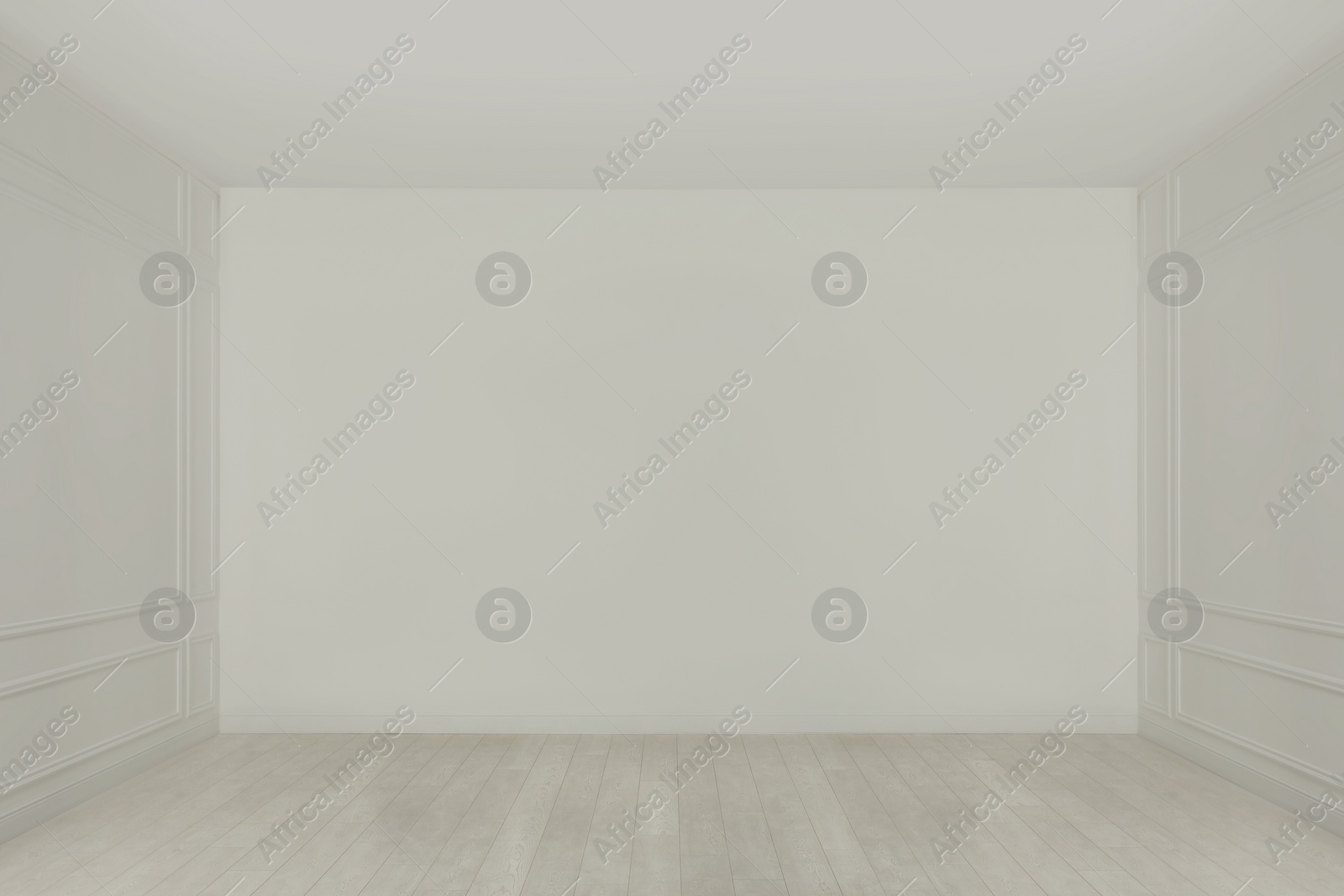 Photo of Empty room with white walls and laminated flooring