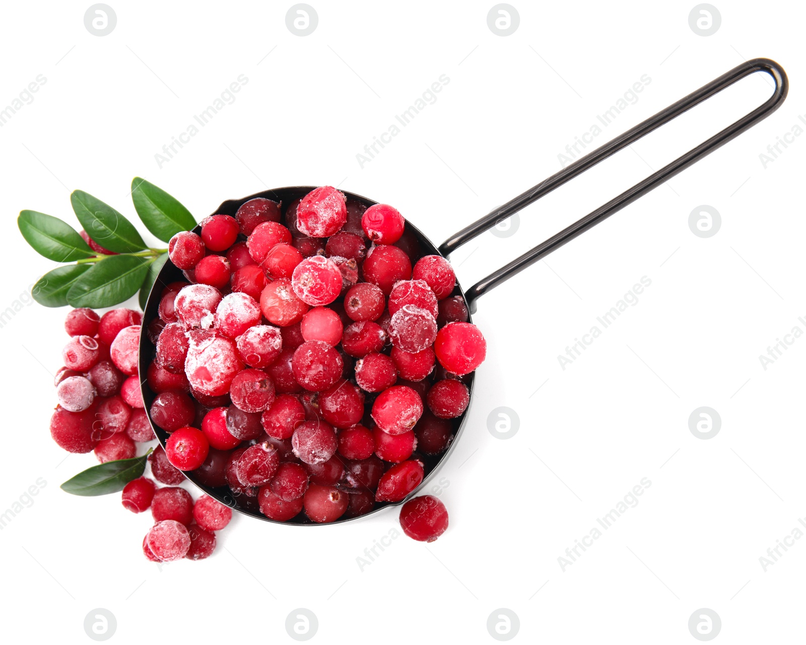 Photo of Frozen red cranberries in scoop and green leaves isolated on white, top view