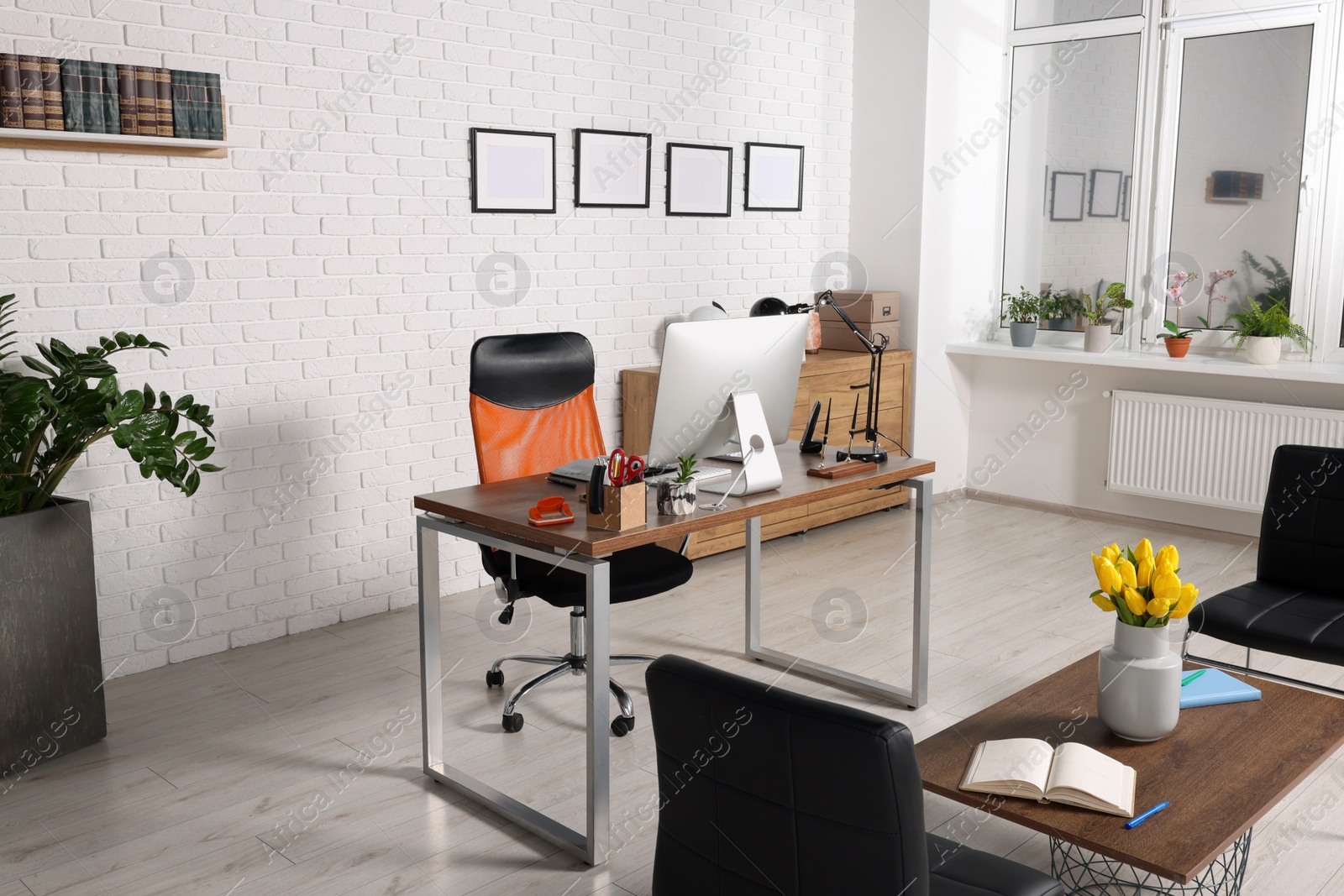 Photo of Stylish director's workplace with comfortable furniture and waiting area in office. Interior design