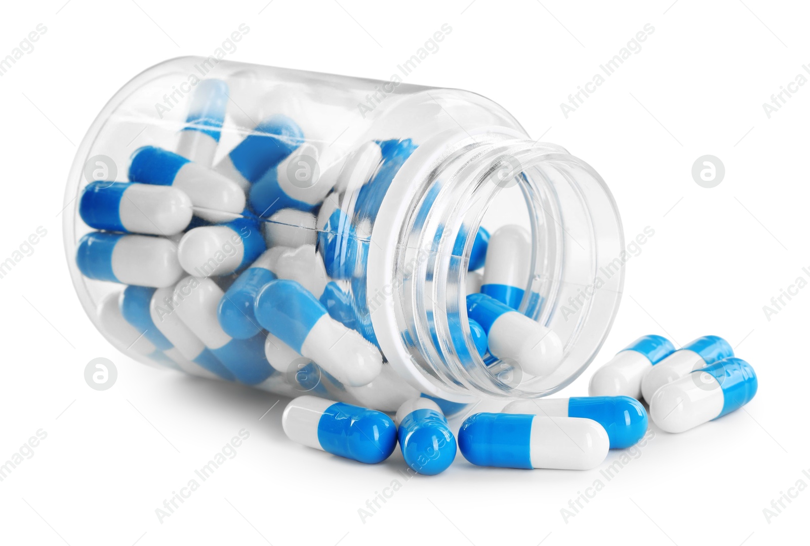 Photo of Scattered antibiotic pills and bottle isolated on white