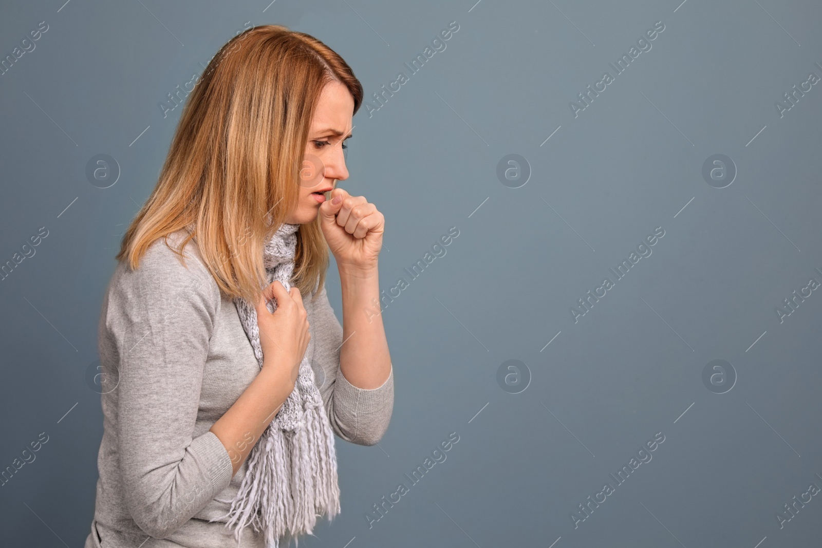 Photo of Young woman coughing on color background