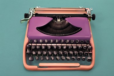 Copywriting concept. Vintage typewriter on turquoise background
