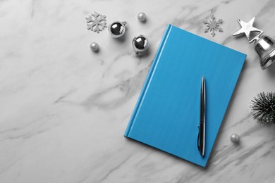 Stylish planner and Christmas decor on white marble background, flat lay with space for text. New Year aims