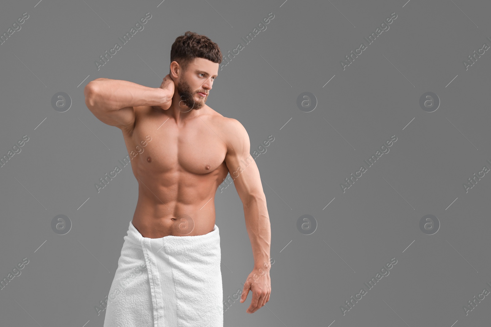 Photo of Handsome muscular man on grey background, space for text. Sexy body