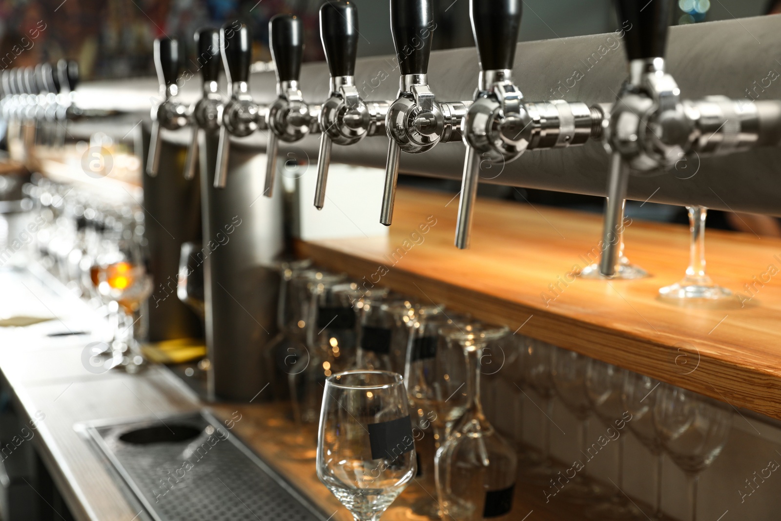 Photo of Row of shiny beer taps in pub