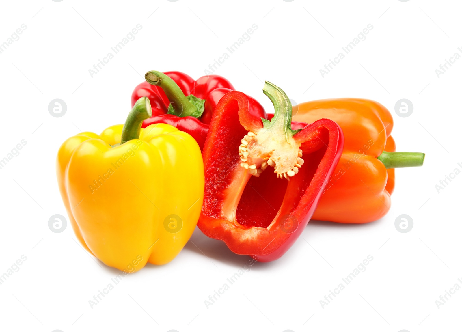 Photo of Whole and cut bell peppers on white background