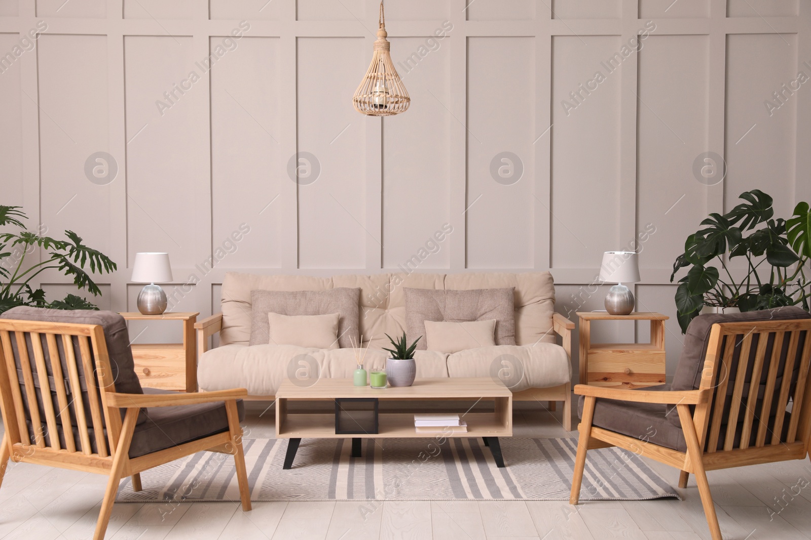 Photo of Stylish living room interior with comfortable sofa, armchairs and beautiful plants