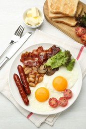 Photo of Delicious breakfast with sunny side up eggs served on white table, flat lay