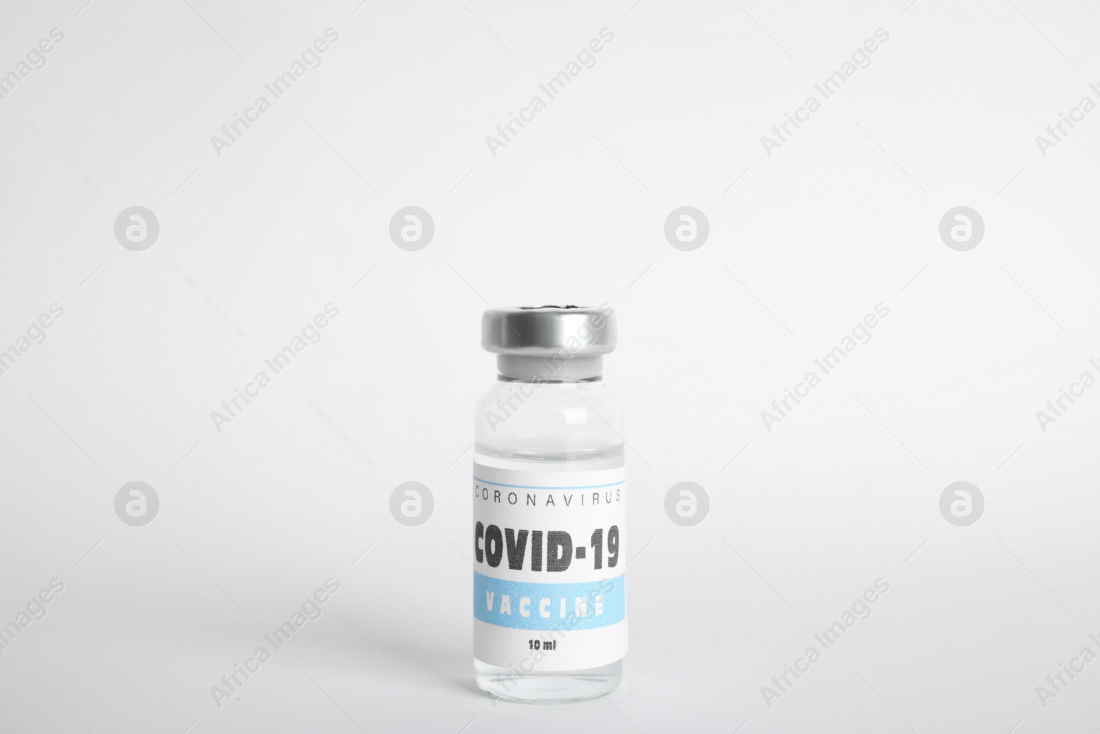 Photo of Vial with coronavirus vaccine on white background