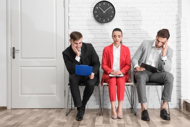 Photo of Group of people waiting for job interview, indoors