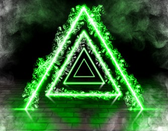Image of Neon triangles and smoke in room with brick floor