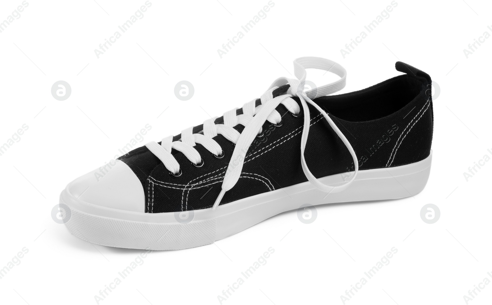 Photo of One black classic old school sneaker isolated on white