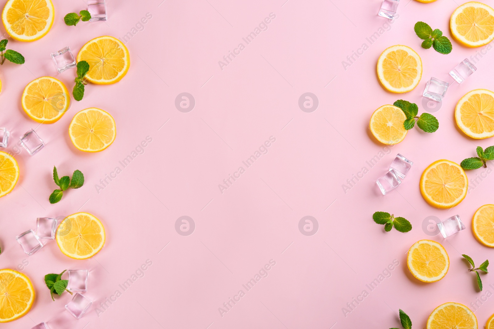 Photo of Frame made of lemon slices, mint and ice on pink background, top view with space for text. Lemonade layout