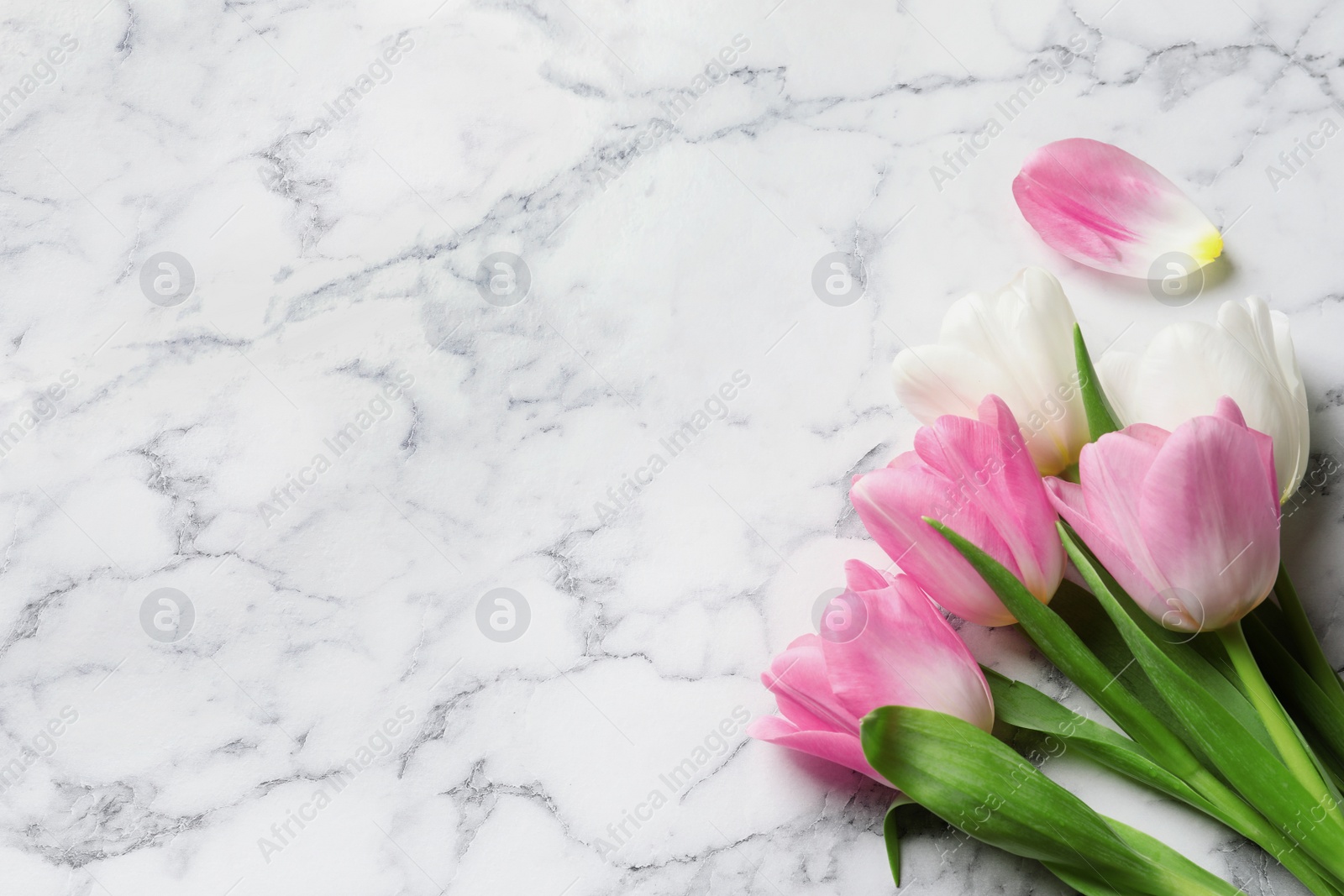 Photo of Beautiful tulips on marble background, top view with space for text. International Women's Day