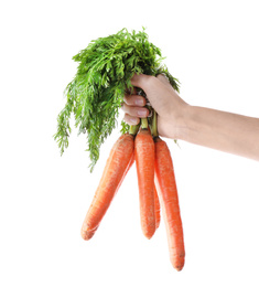 Photo of Woman holding bunch of fresh ripe carrots on white background, closeup