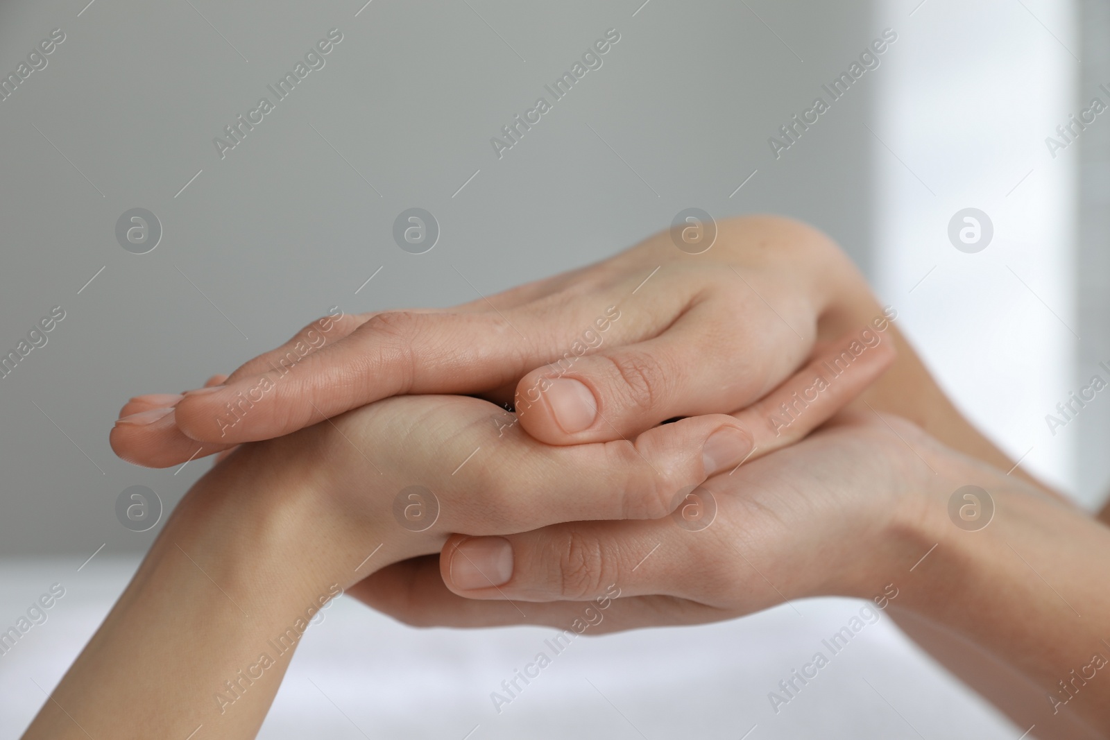 Photo of Woman receiving hand massage in wellness center, closeup