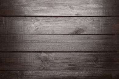 Photo of Texture of dark wooden surface as background, top view