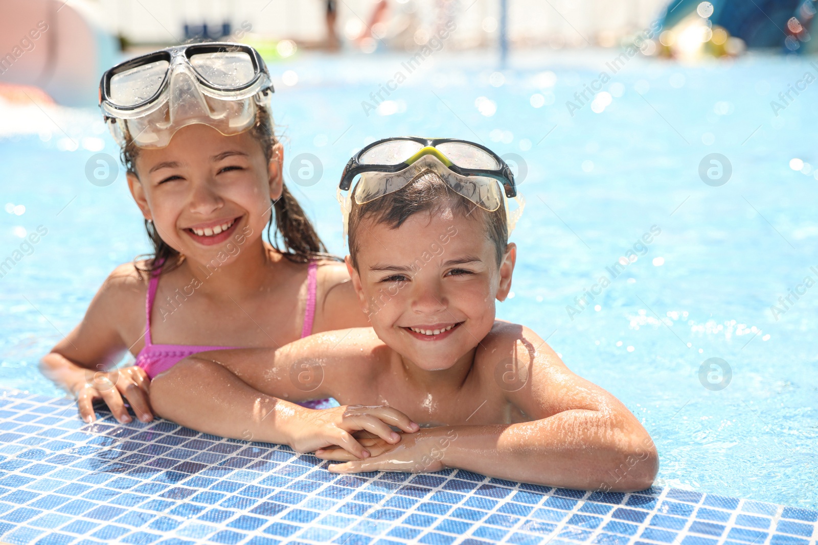 Photo of Little children wearing diving mask in swimming pool. Summer vacation