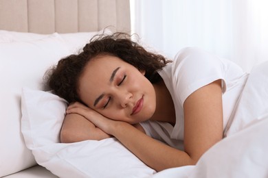 Photo of Beautiful African American woman sleeping in bed at home