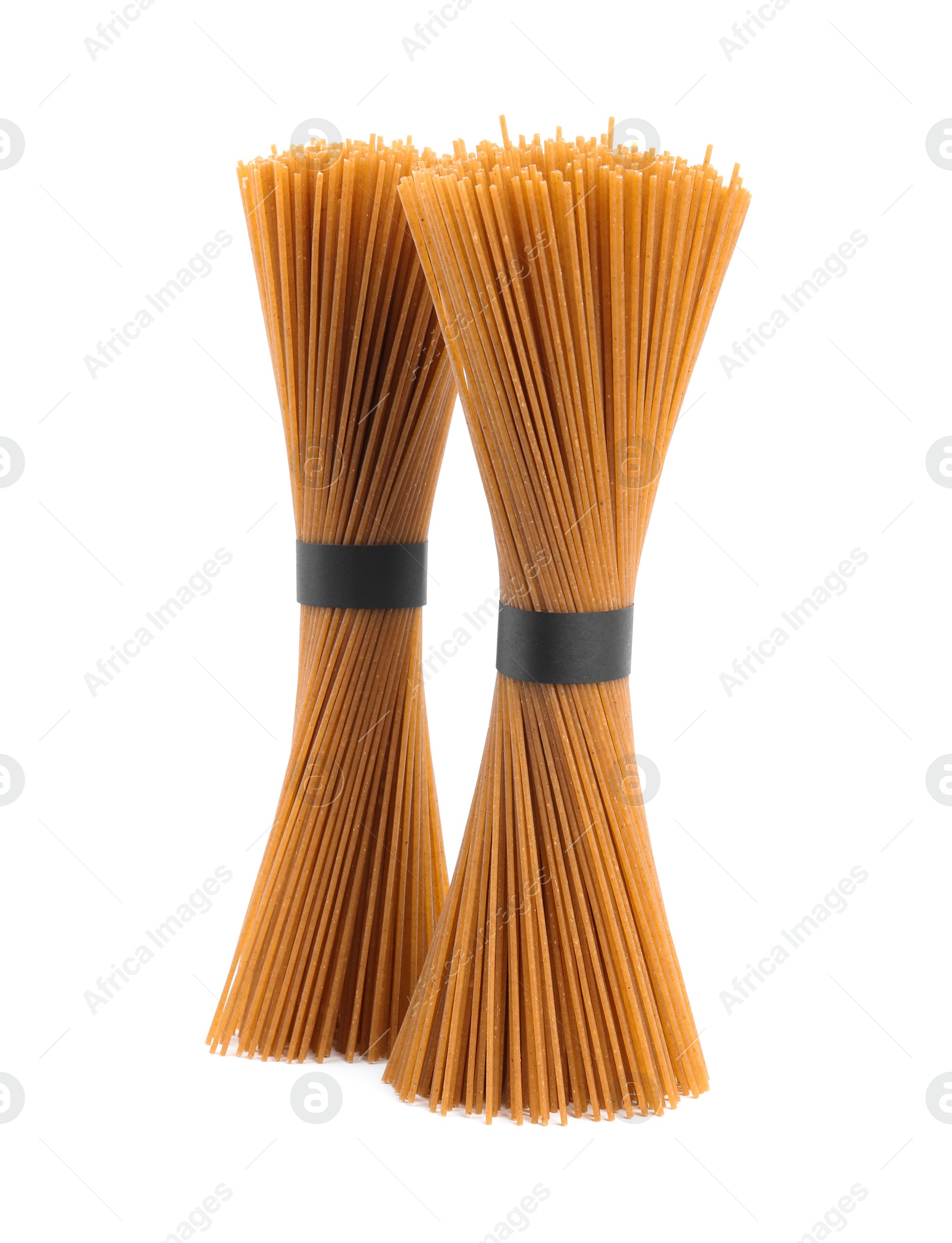 Photo of Uncooked buckwheat noodles isolated on white. Japanese cuisine