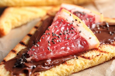 Tasty toast with grapefruit, chocolate paste and chia seeds, closeup