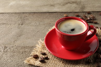 Photo of Cup of aromatic coffee on wooden table. Space for text